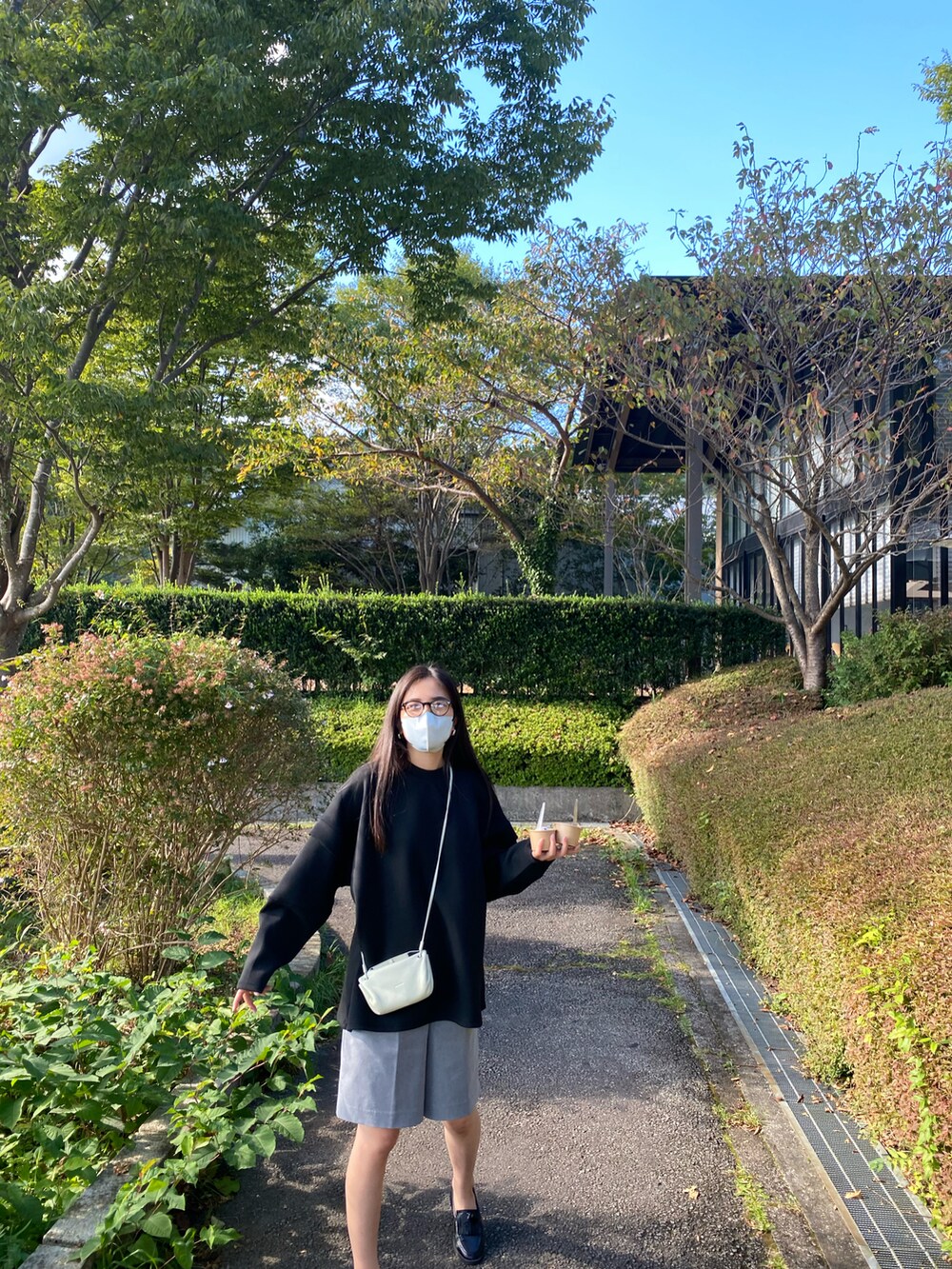 ブラック系のTシャツ/カットソー、グレー系のその他パンツ、ブラック系のローファーを着用したレディースの秋コーディネートの2枚目の写真