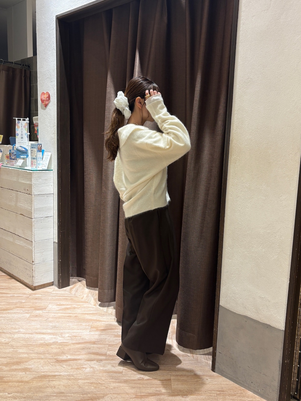 ホワイト系のカーディガン/ボレロ、ブラウン系のその他パンツ、ブラウン系のブーツを着用したレディースの秋コーディネートの2枚目の写真