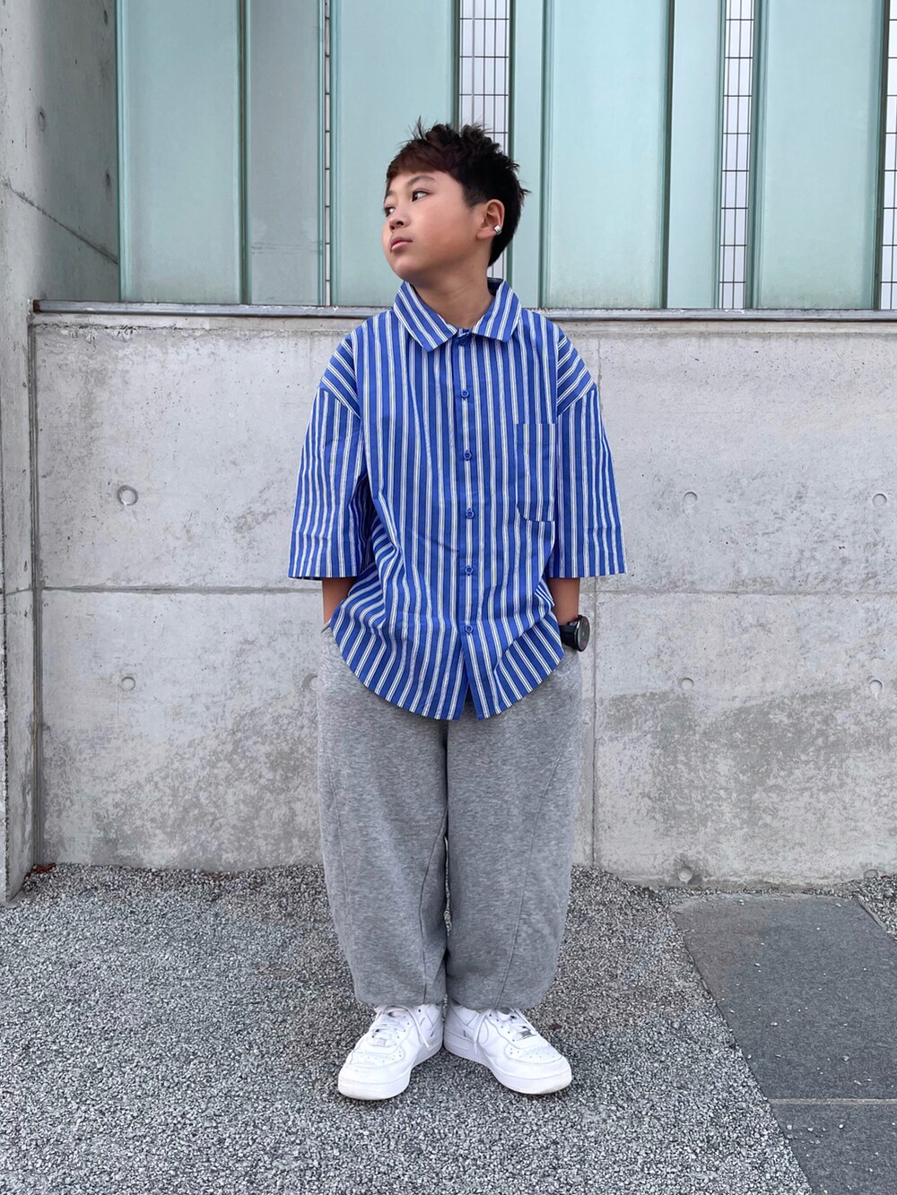 ブルー系のシャツ/ブラウス、グレー系のスウェットパンツ、ホワイト系のスニーカーを着用したキッズの春コーディネートの2枚目の写真