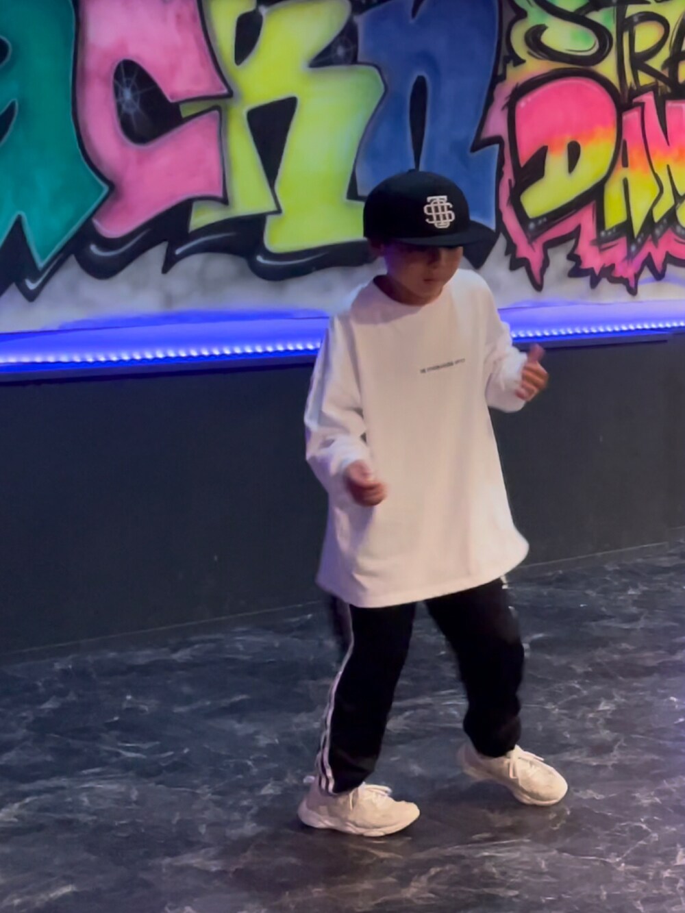 ホワイト系のTシャツ/カットソー、ブラック系のスウェットパンツ、イエロー系のスニーカーを着用したキッズの春コーディネートの4枚目の写真