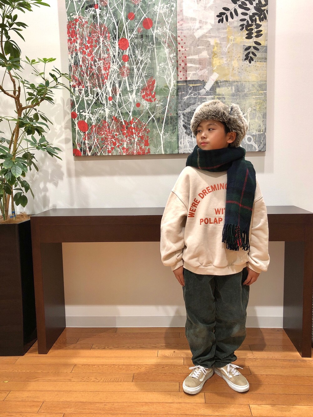 グレー系のブルゾン、ホワイト系のスウェット、グリーン系のパンツを着用したキッズの冬コーディネートの3枚目の写真