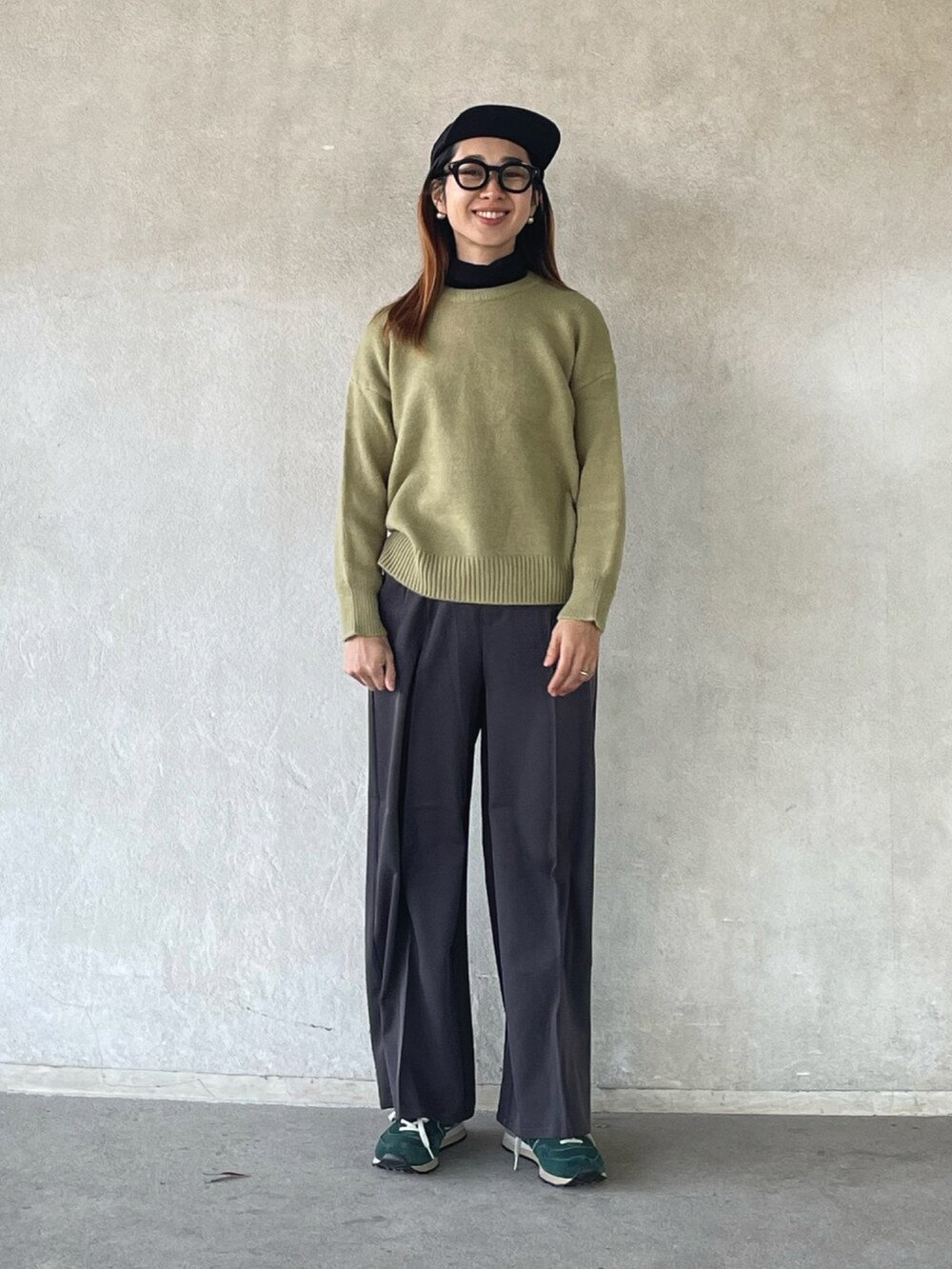 ブラック系のダウンジャケット/コート、グリーン系のニット/セーター、グレー系のその他パンツを着用したレディースの冬コーディネートの3枚目の写真
