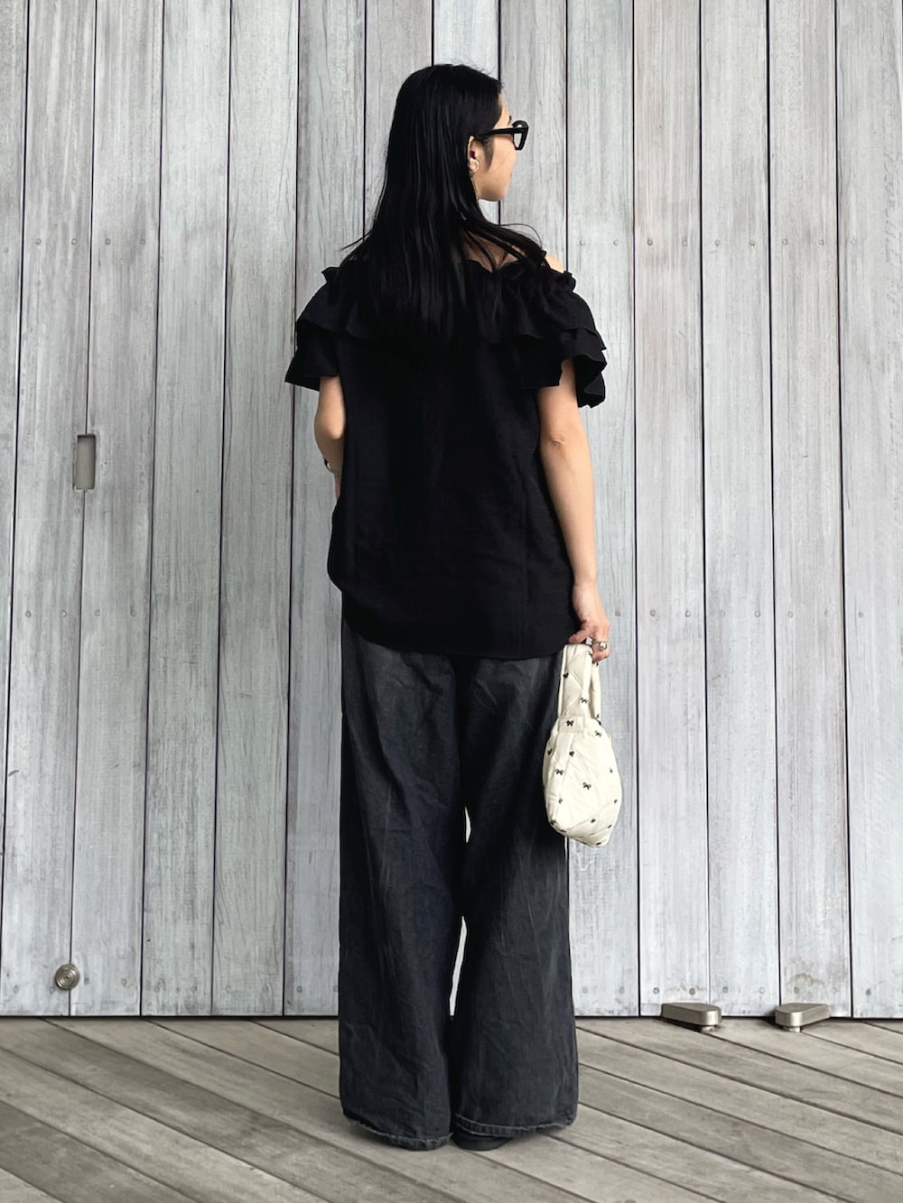 ブラック系のシャツ/ブラウス、ブラック系のデニムパンツ、ブラック系のサンダルを着用したレディースの春コーディネートの4枚目の写真