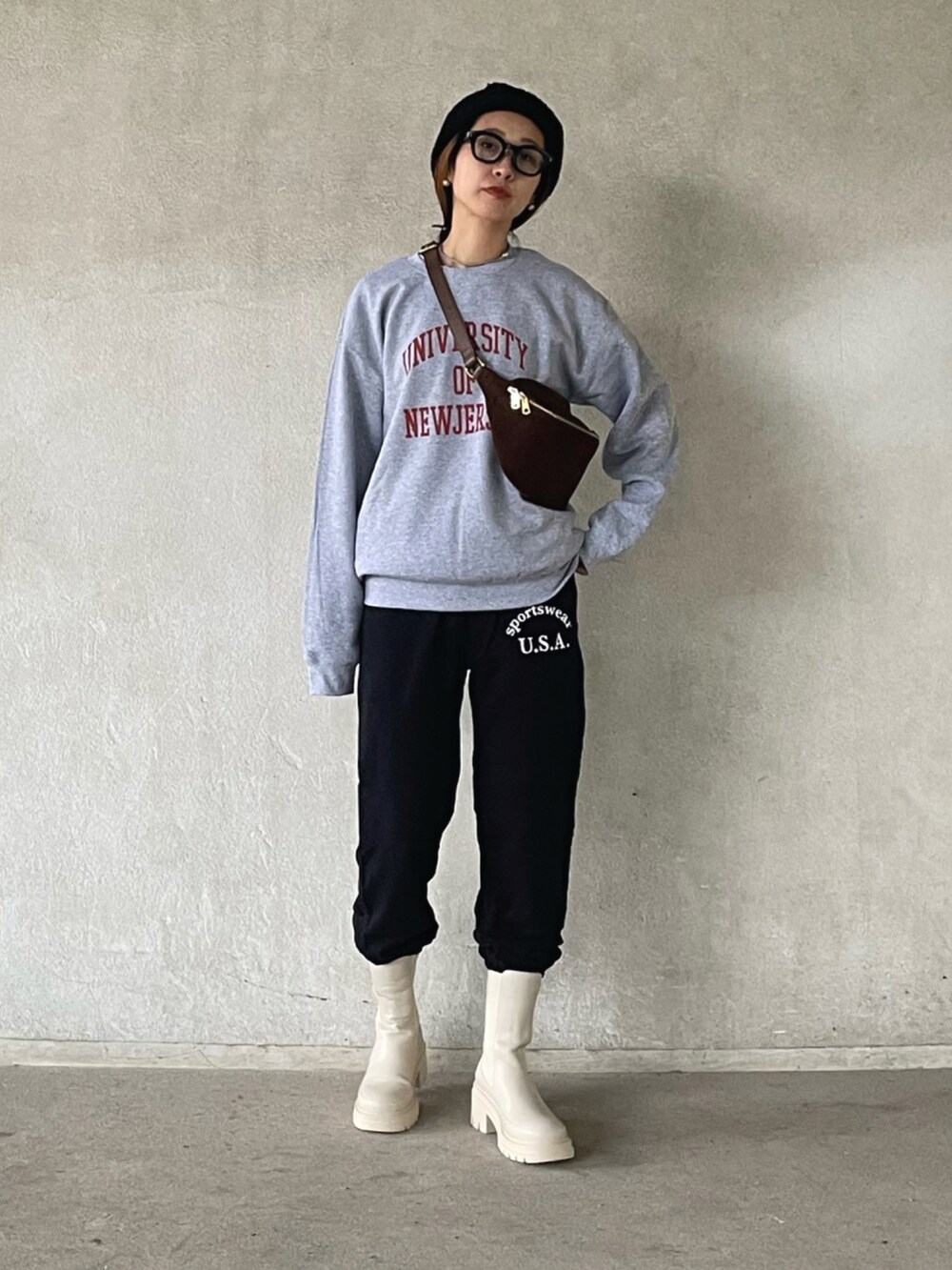 グレー系のスウェット、ブラック系のスウェットパンツ、ベージュ系のブーツを着用したレディースの秋コーディネートの4枚目の写真