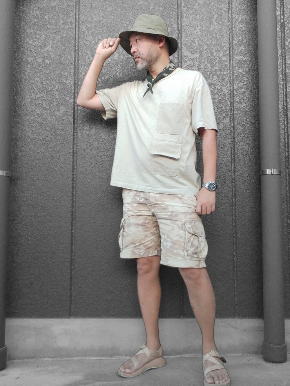 ベージュ系のTシャツ/カットソー、ベージュ系のカーゴパンツ、ベージュ系のサンダルを着用したメンズの夏コーディネートの3枚目の写真