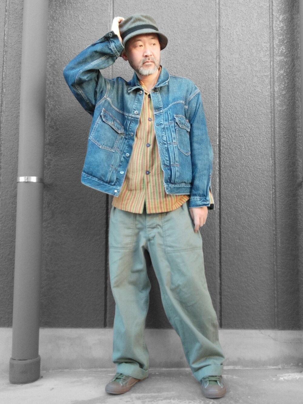 グリーン系のカーゴパンツ、ブラック系のスニーカー、ブルー系のデニムジャケットを着用したメンズの冬コーディネートの4枚目の写真