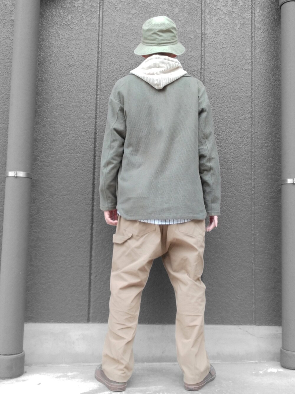 ベージュ系のパンツ、グリーン系のスニーカー、ベージュ系のパーカーを着用したメンズの春コーディネートの5枚目の写真