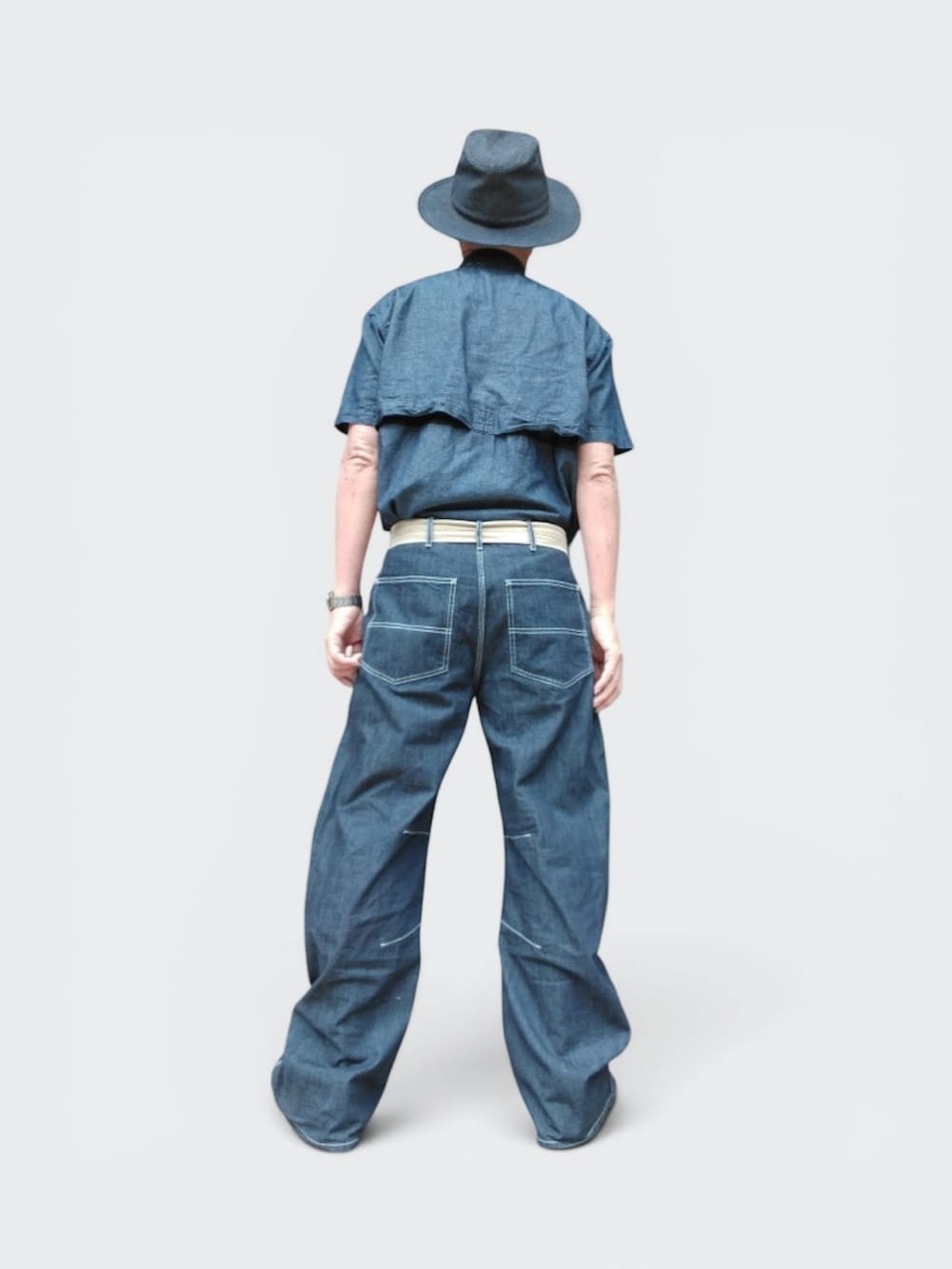 ブルー系のデニムパンツ、ブラック系のスニーカー、ブルー系のシャツ/ブラウスを着用したメンズの夏コーディネートの5枚目の写真