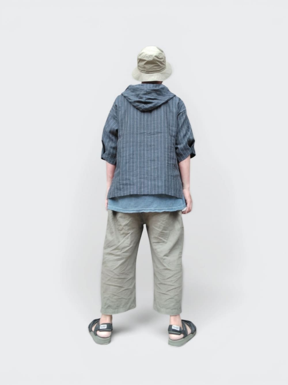 グリーン系のその他パンツ、グリーン系のサンダル、ブルー系のパーカーを着用したメンズの夏コーディネートの5枚目の写真