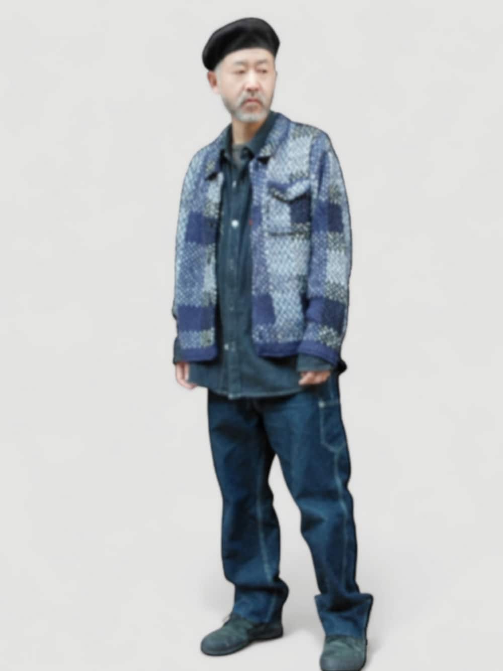 ブラック系のスニーカー、ブルー系のデニムパンツ、ブルー系のニット/セーターを着用したメンズの冬コーディネートの4枚目の写真