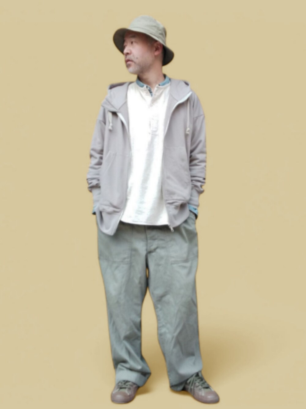 グリーン系のカーゴパンツ、ホワイト系のTシャツ/カットソー、グレー系のパーカーを着用したメンズの春コーディネートの2枚目の写真