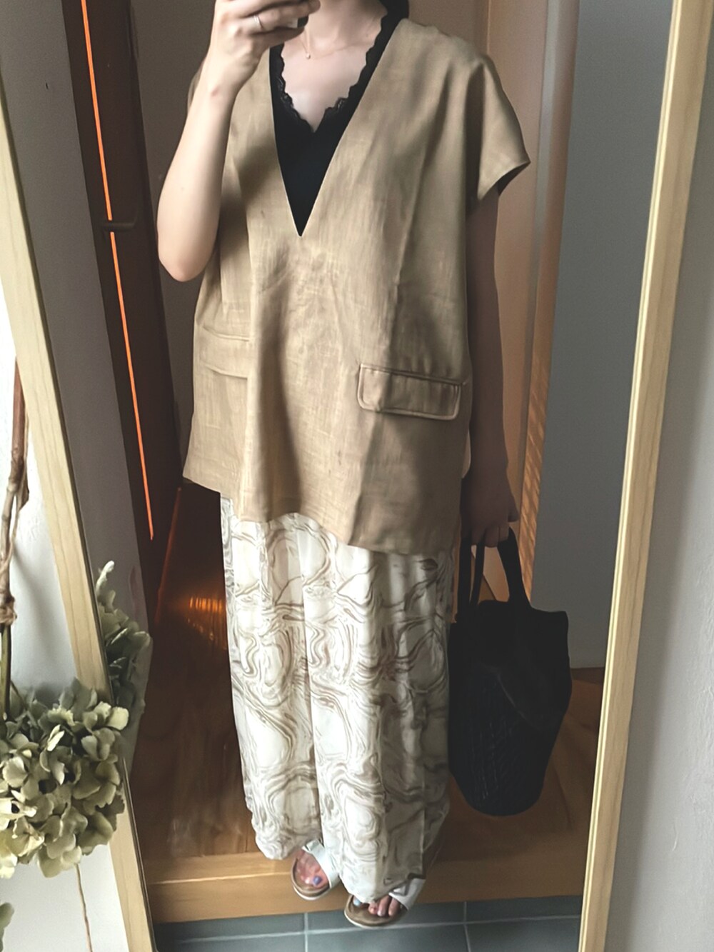 ベージュ系のトップス、ベージュ系のパンツ、ホワイト系のサンダルを着用したレディースの夏コーディネートの2枚目の写真