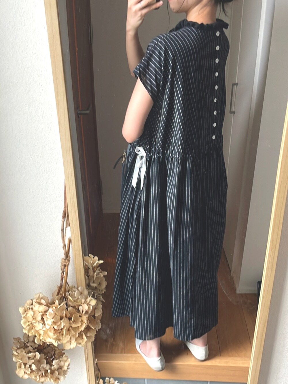 ホワイト系のシューズ、ブルー系のバッグ、ブラック系のワンピースを着用したレディースの秋コーディネートの2枚目の写真