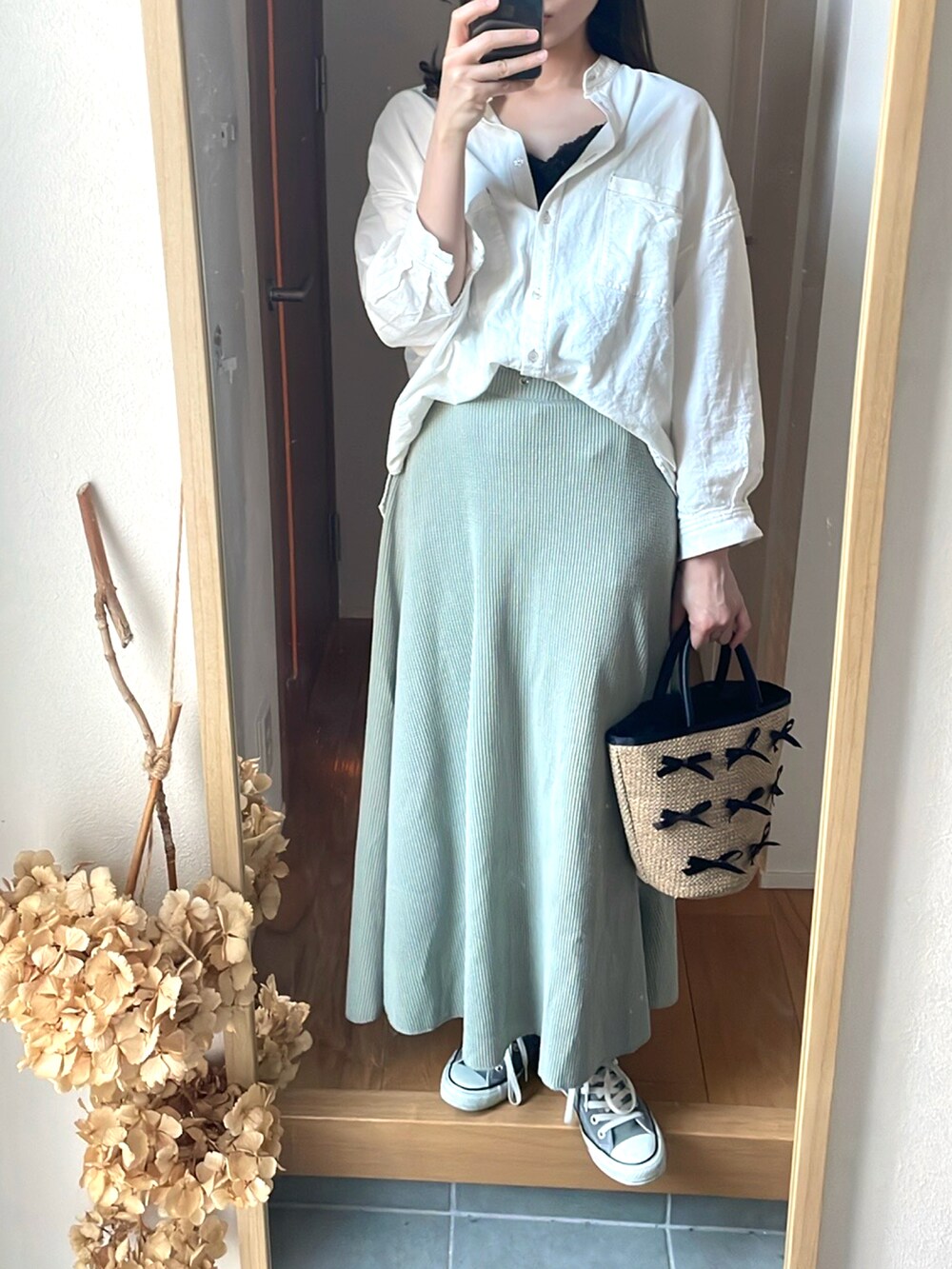 グリーン系のスカート、ホワイト系のシャツ/ブラウス、ベージュ系のトートバッグを着用したレディースの春コーディネートの3枚目の写真