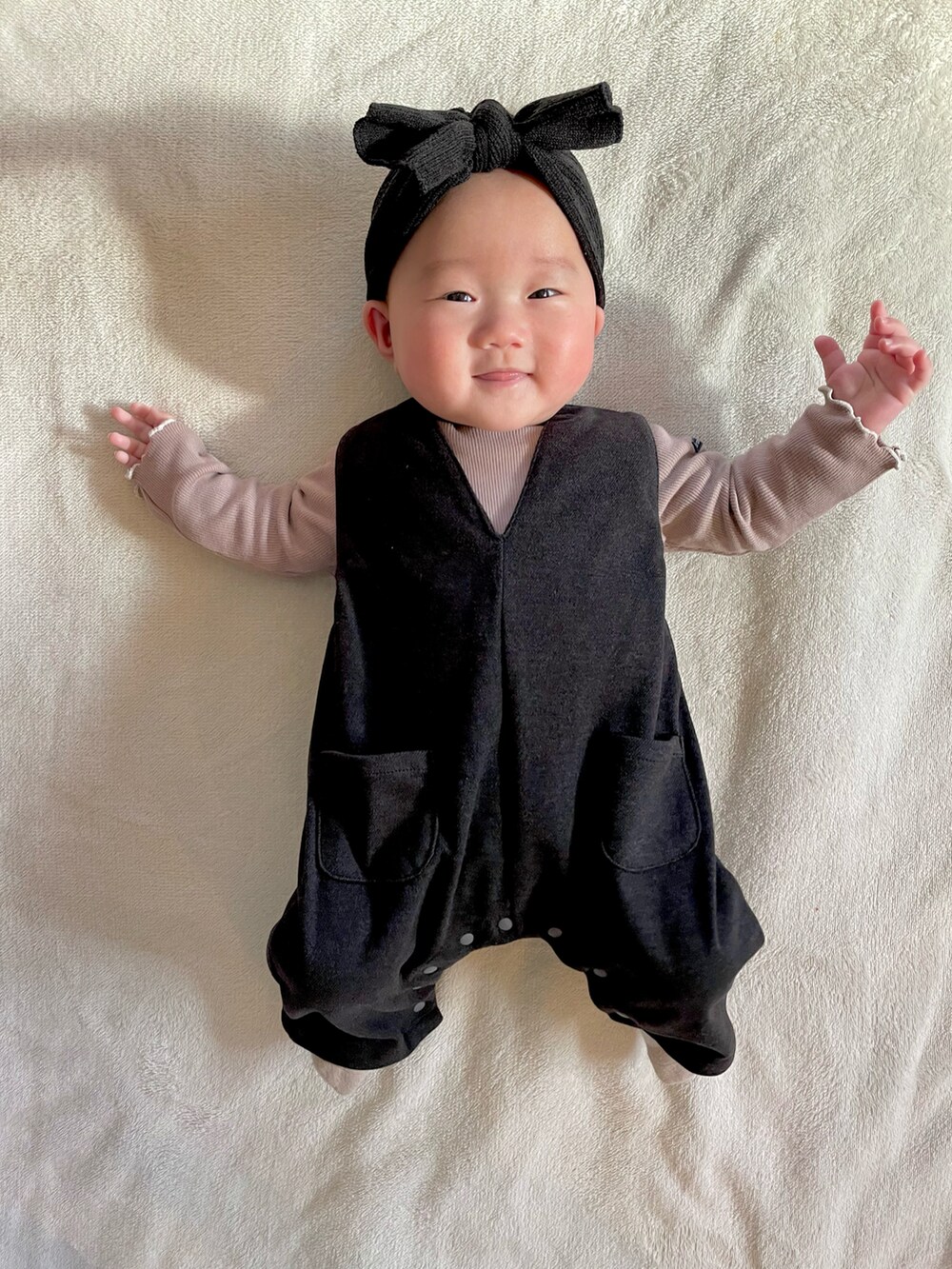 ブラック系のサロペット/オーバーオール、ブラウン系のロンパースを着用したキッズの冬コーディネートの3枚目の写真