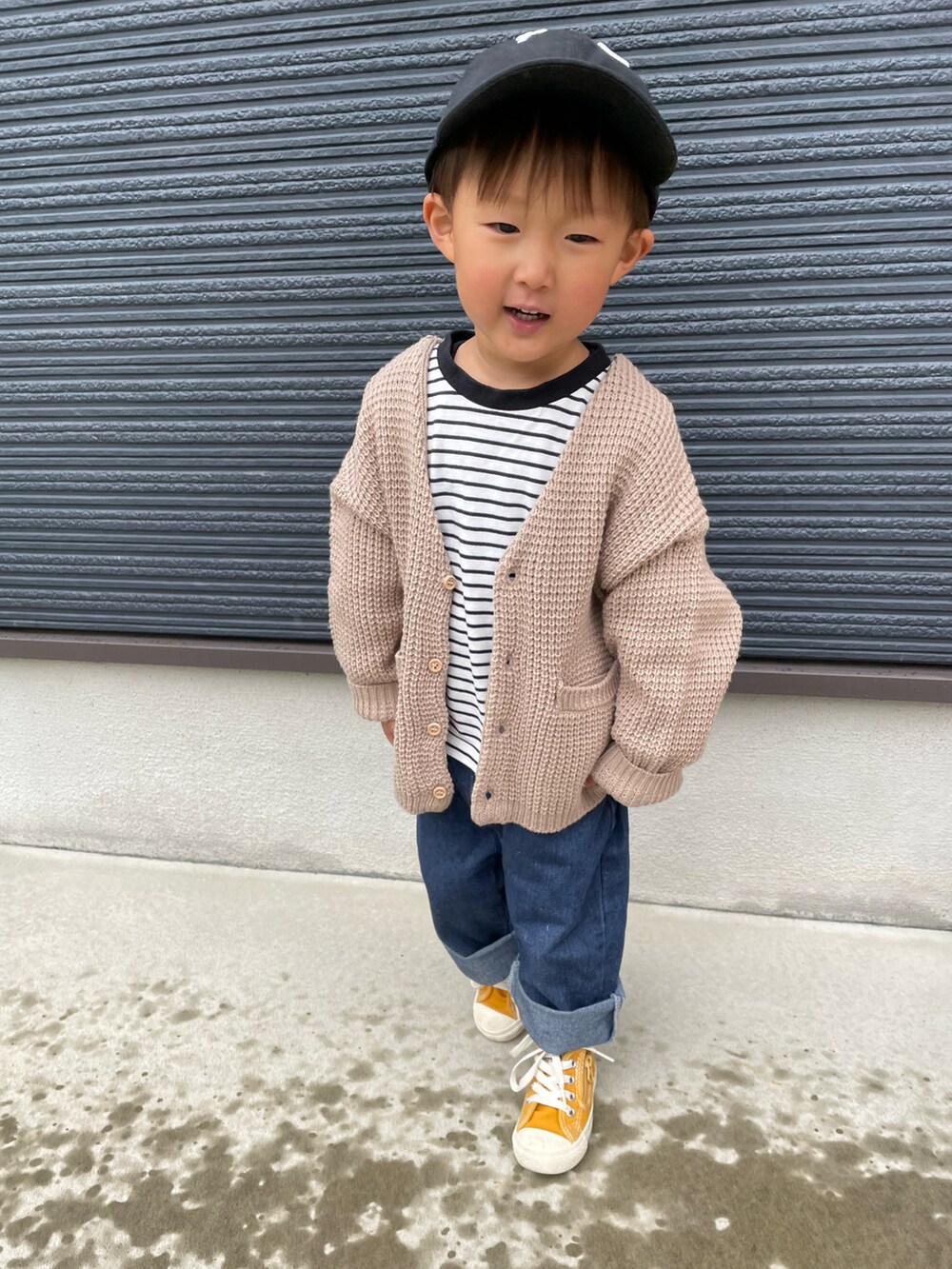 ブラック系のTシャツ/カットソー、ブルー系のデニムパンツ、イエロー系のスニーカーを着用したキッズの春コーディネートの4枚目の写真