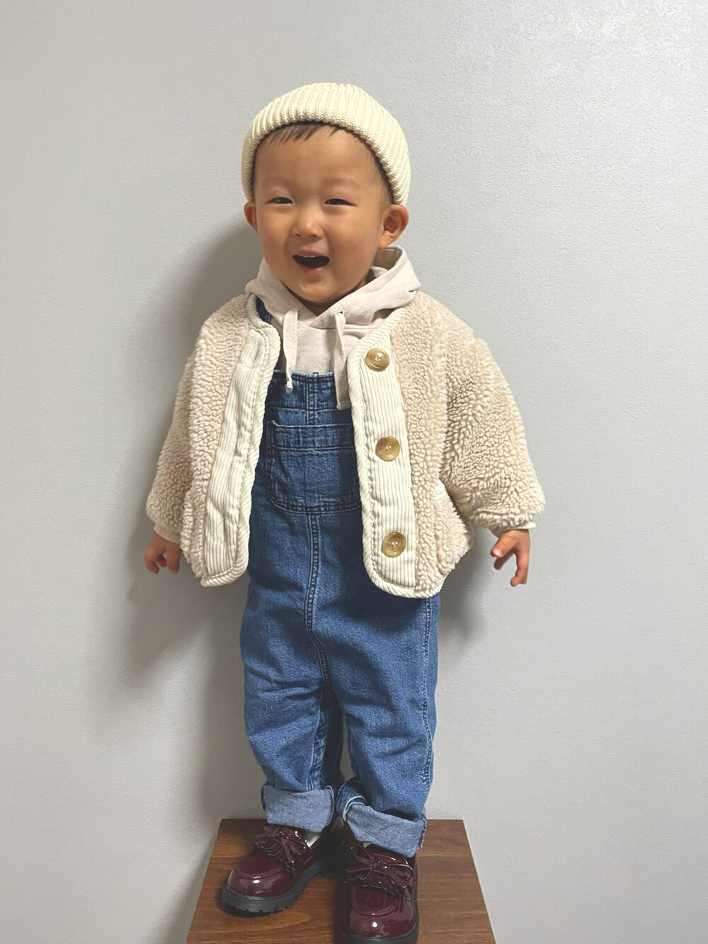 ホワイト系のノーカラージャケット、ブルー系のサロペット/オーバーオール、その他のローファーを着用したキッズの冬コーディネートの2枚目の写真