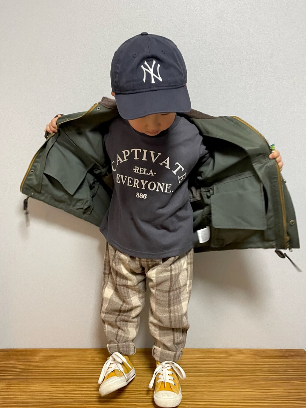 グリーン系のその他アウター、ホワイト系のTシャツ/カットソー、イエロー系のスニーカーを着用したキッズの春コーディネートの3枚目の写真