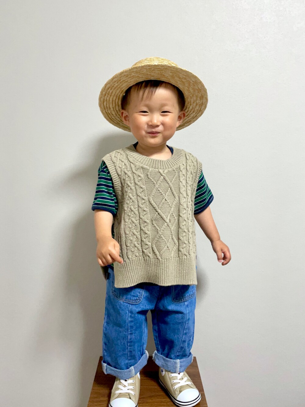 グリーン系のベスト、グリーン系のTシャツ/カットソー、ブルー系のデニムパンツを着用したキッズの春コーディネートの3枚目の写真