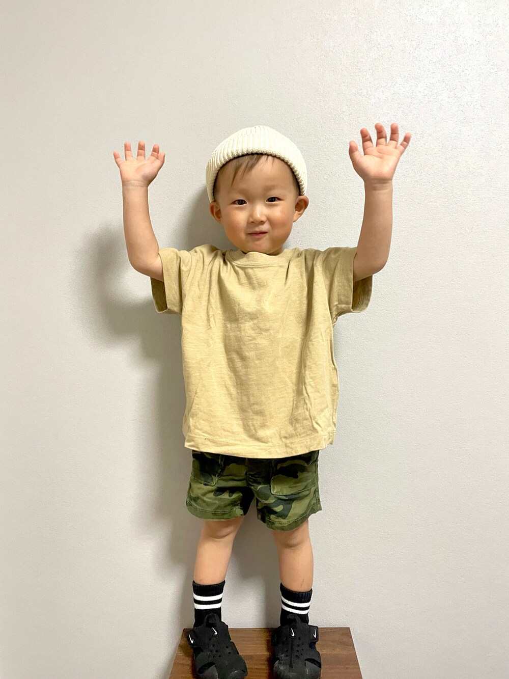 グリーン系のカーゴパンツ、ブラック系のサンダル、ホワイト系のニットキャップ/ビーニーを着用したキッズの春コーディネートの4枚目の写真