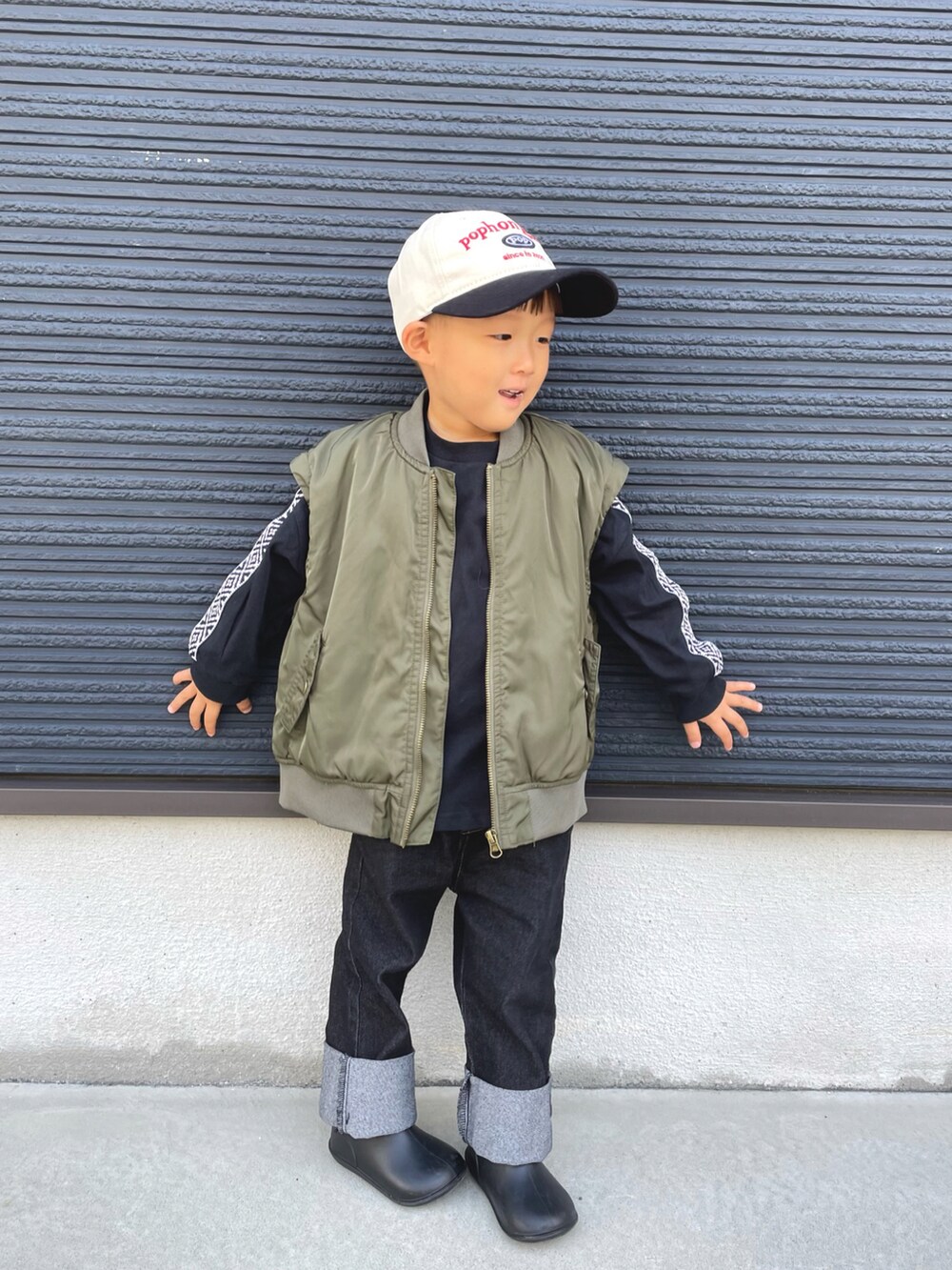 グリーン系のMA-1、ブラック系のTシャツ/カットソー、ブルー系のデニムパンツを着用したキッズの秋コーディネートの3枚目の写真