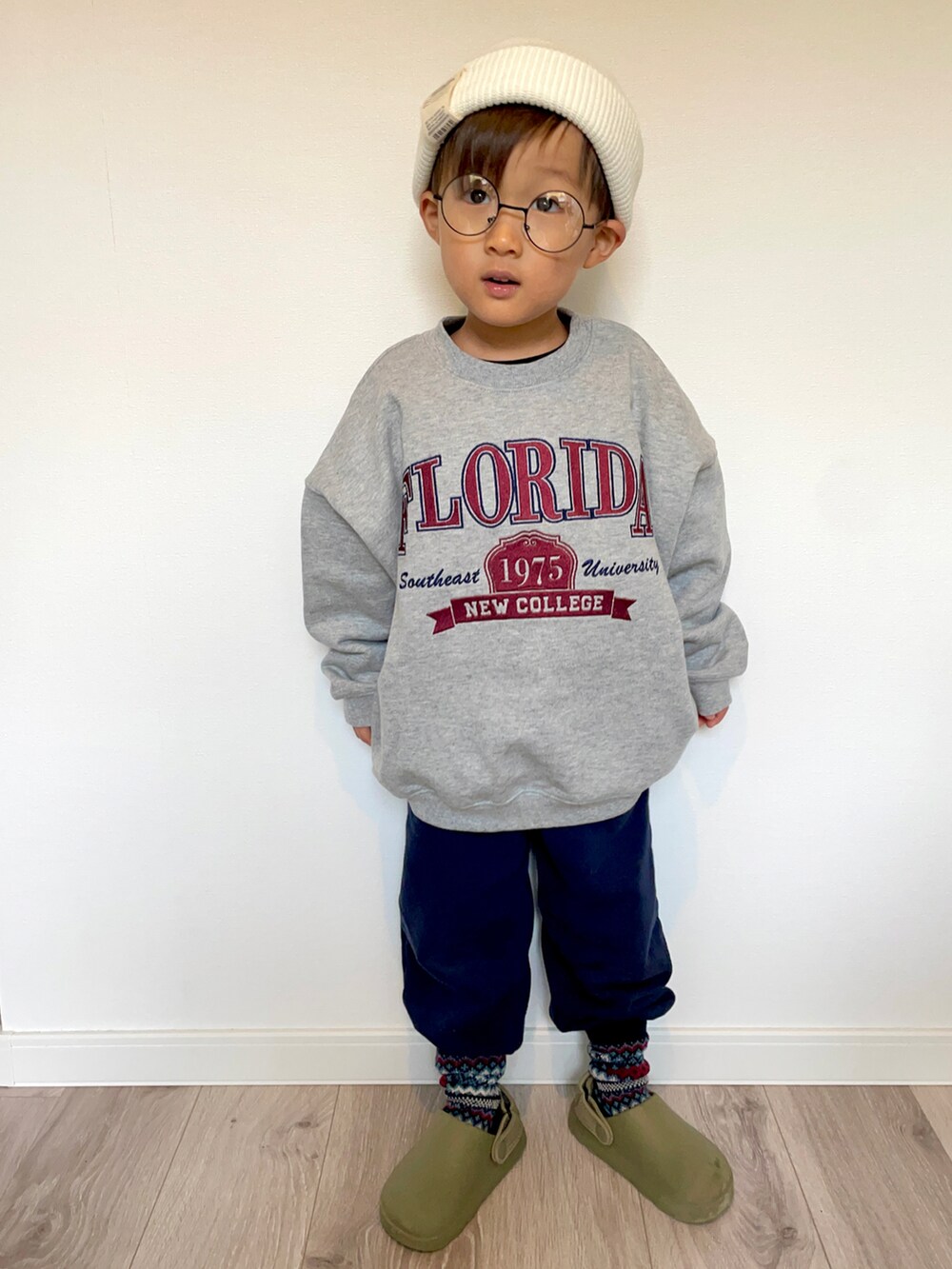 グレー系のスウェット、ブルー系のスウェットパンツ、グリーン系のサンダルを着用したキッズの冬コーディネートの3枚目の写真