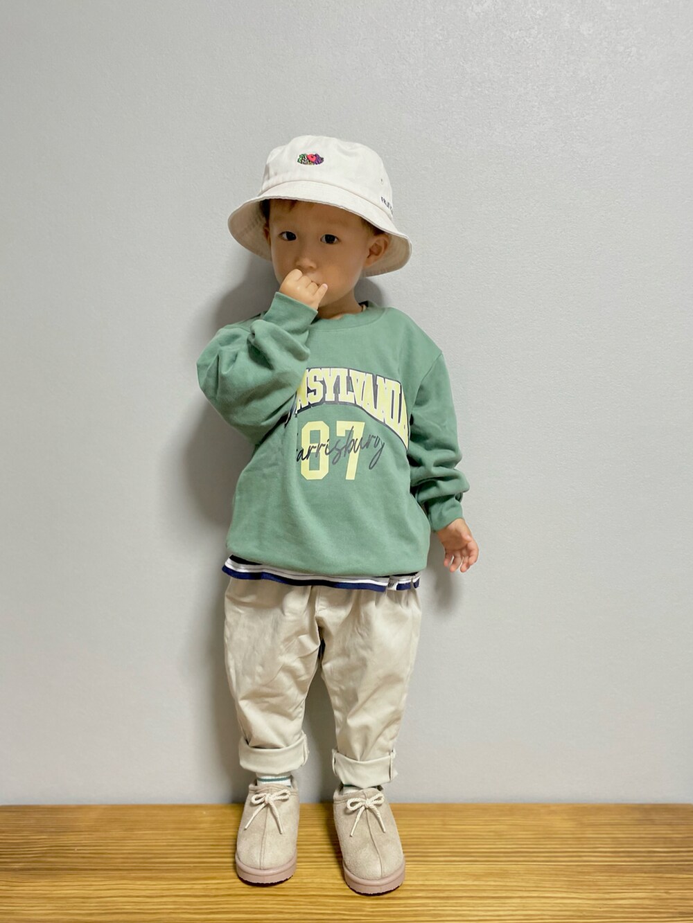 グリーン系のスウェット、ブルー系のTシャツ/カットソー、ホワイト系のパンツを着用したキッズの秋コーディネートの2枚目の写真