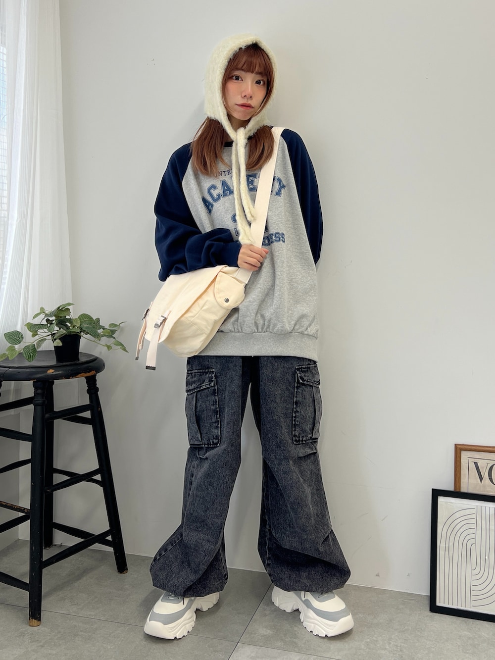 ブルー系のスウェット、ブラック系のデニムパンツ、グレー系のスニーカーを着用したレディースの冬コーディネートの3枚目の写真