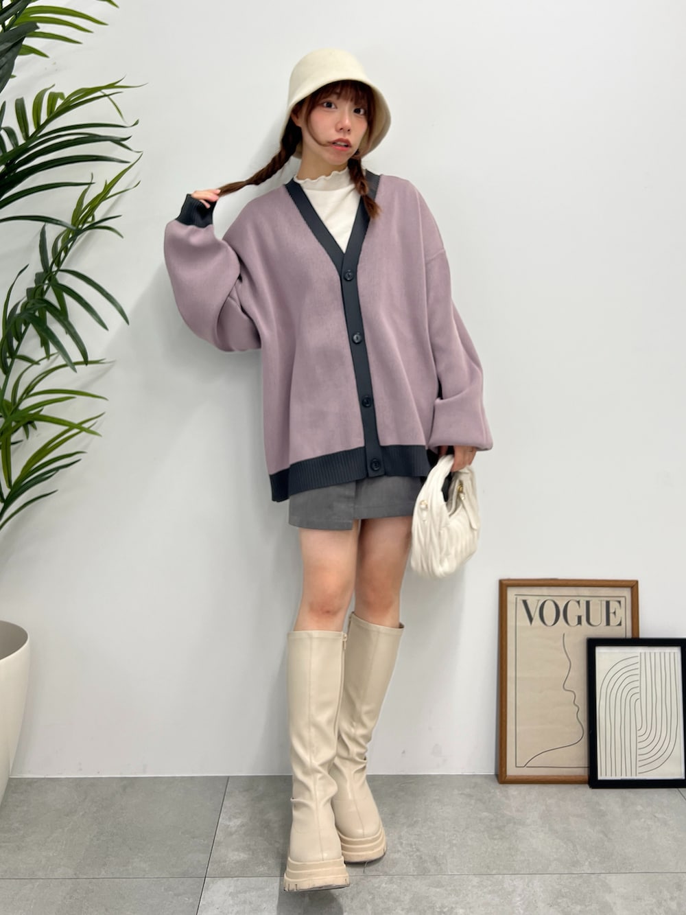 グレー系のカーディガン/ボレロ、ホワイト系のブーツ、ホワイト系のTシャツ/カットソーを着用したレディースの冬コーディネートの2枚目の写真