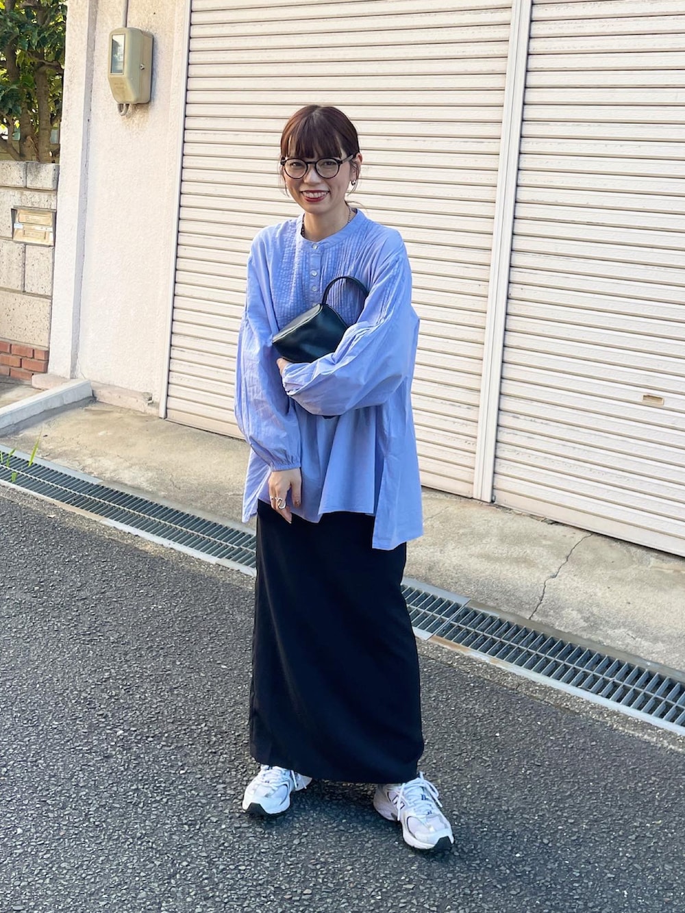 ブルー系のシャツ/ブラウス、ブラック系のスカートを着用したレディースの秋コーディネートの2枚目の写真