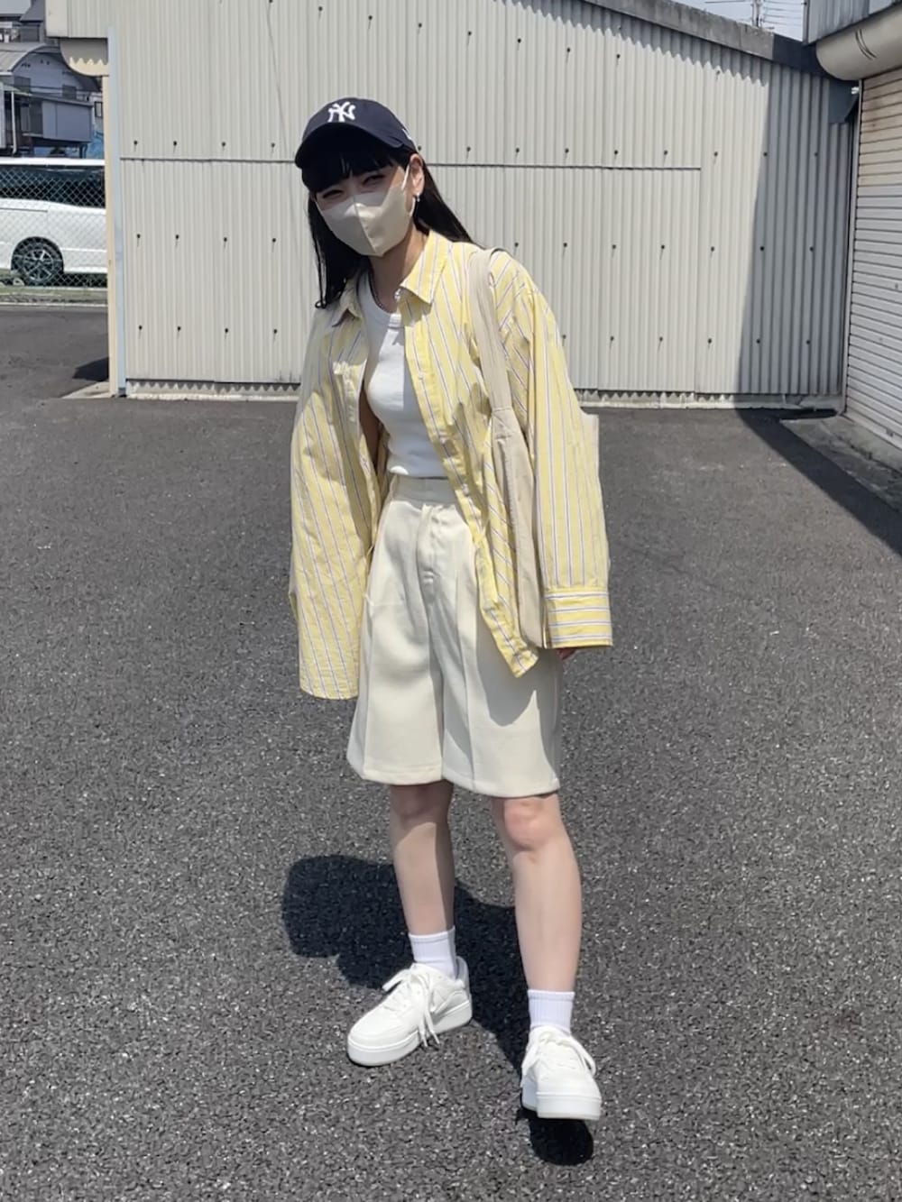 イエロー系のシャツ/ブラウス、ホワイト系のその他パンツ、ホワイト系のトートバッグを着用したレディースの春コーディネートの2枚目の写真