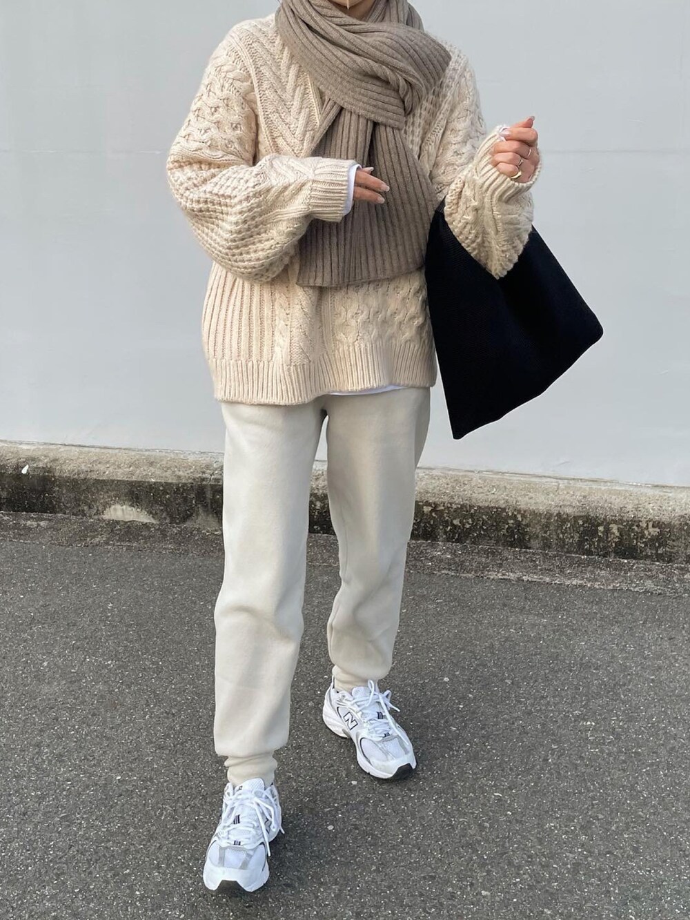 ベージュ系のその他パンツ、ホワイト系のスニーカー、ベージュ系のマフラーを着用したレディースの冬コーディネートの2枚目の写真