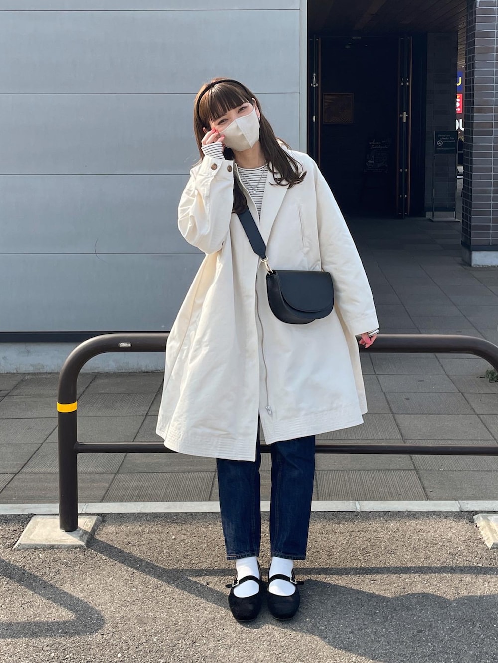 ホワイト系のトレンチコート、ホワイト系のTシャツ/カットソー、ブラック系のショルダーバッグを着用したレディースの春コーディネートの4枚目の写真