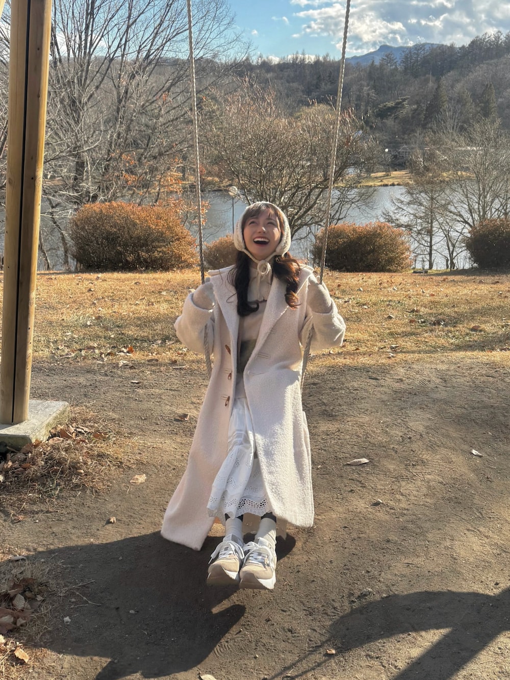 ホワイト系のジャケット/アウター、ブラウン系のショルダーバッグ、ホワイト系のニット/セーターを着用したレディースの冬コーディネートの4枚目の写真