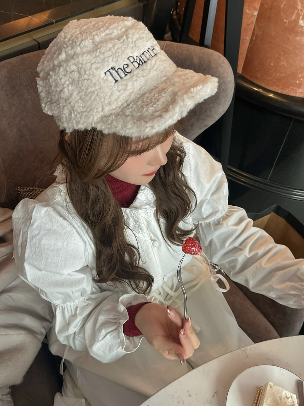 ホワイト系のワンピース、ホワイト系のその他アウター、レッド系のトップスを着用したレディースの冬コーディネートの5枚目の写真