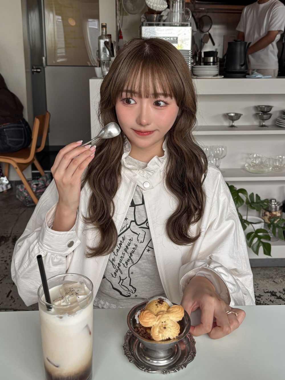 ブルー系のレインシューズ、ブルー系のシューズ、ベージュ系のショルダーバッグを着用したレディースの秋コーディネートの2枚目の写真