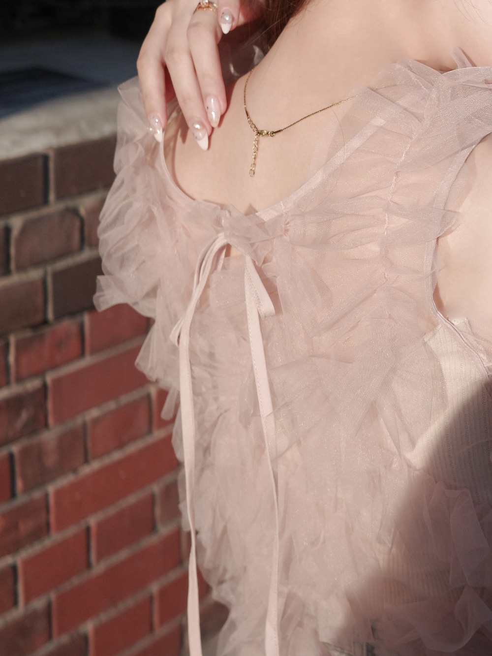 ブラウン系のジャケット/アウター、ピンク系のトップス、ブルー系のデニムパンツを着用したレディースの冬コーディネートの4枚目の写真