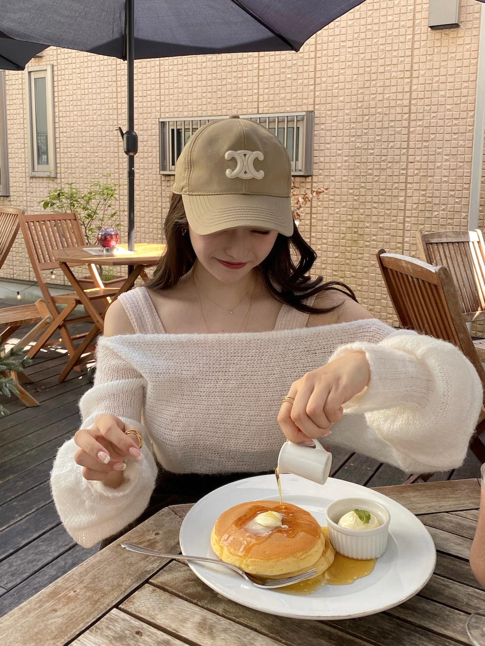 ブラウン系のスカート、ホワイト系のサンダル、ブラウン系のバッグを着用したレディースの秋コーディネートの3枚目の写真