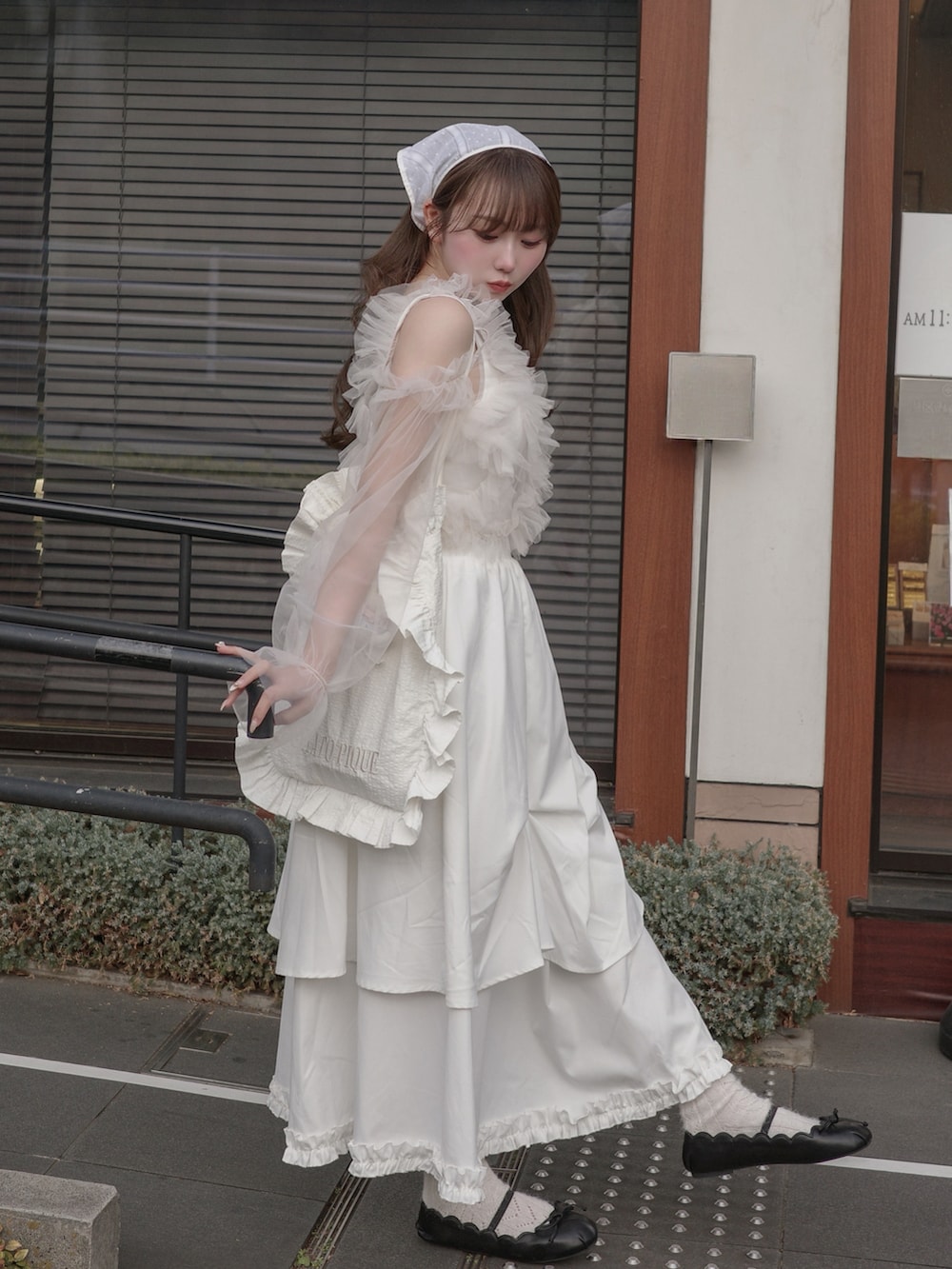 ホワイト系のスカート、ホワイト系のトップス、ホワイト系のトートバッグを着用したレディースの春コーディネートの2枚目の写真