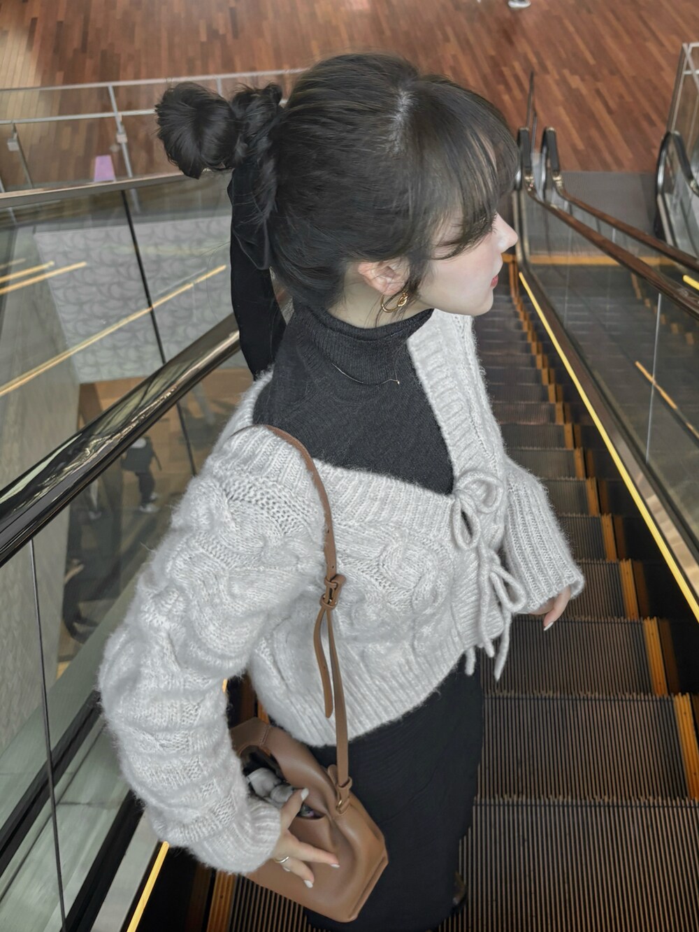 ホワイト系のニット/セーター、グレー系のトップス、ブラウン系のバッグを着用したレディースの秋コーディネートの5枚目の写真