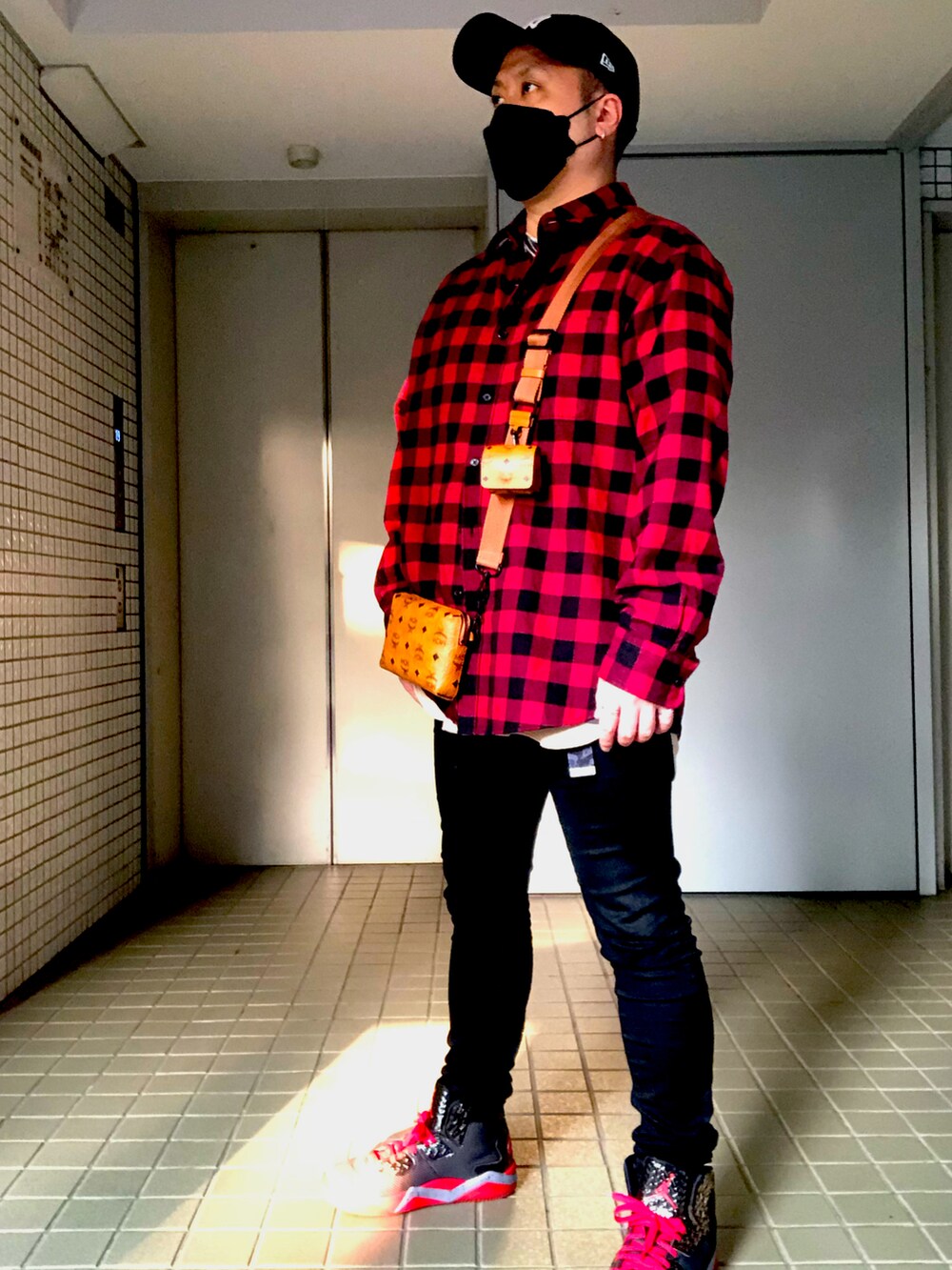 レッド系のシャツ/ブラウス、ブラウン系のショルダーバッグ、ブラック系のパンツを着用したメンズの春コーディネートの3枚目の写真