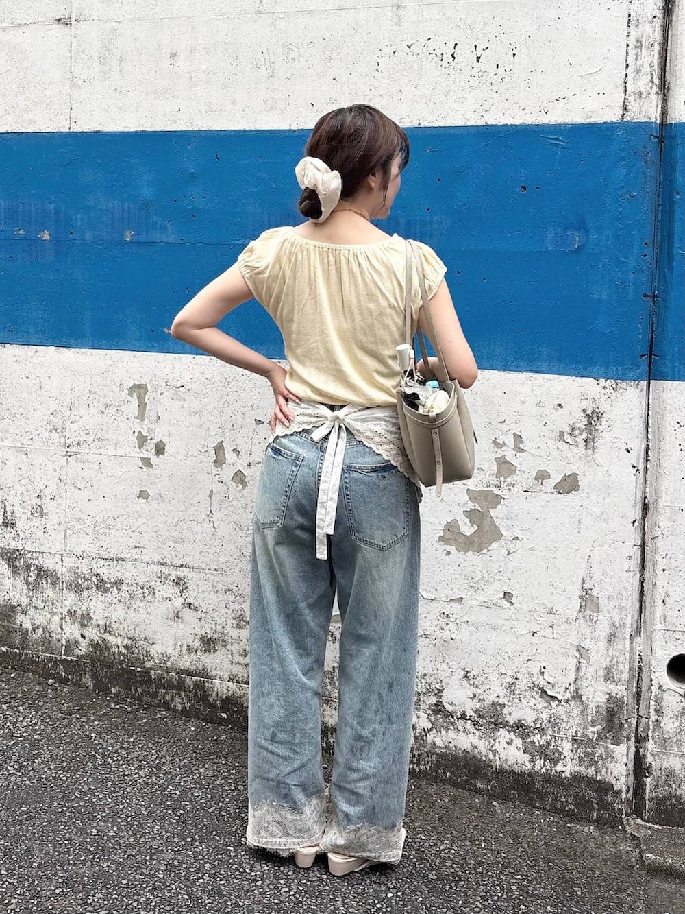 ブルー系のデニムパンツ、ゴールド系のチョーカー、ホワイト系のバンダナ/スカーフを着用したレディースの夏コーディネートの4枚目の写真