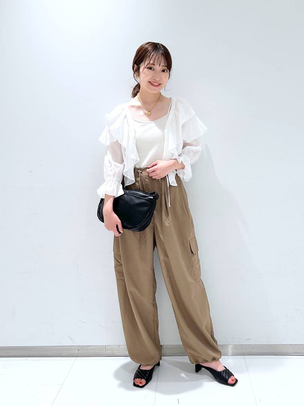 ホワイト系のキャミソール、ブラウン系のその他パンツ、ホワイト系のシャツ/ブラウスを着用したレディースの夏コーディネートの2枚目の写真
