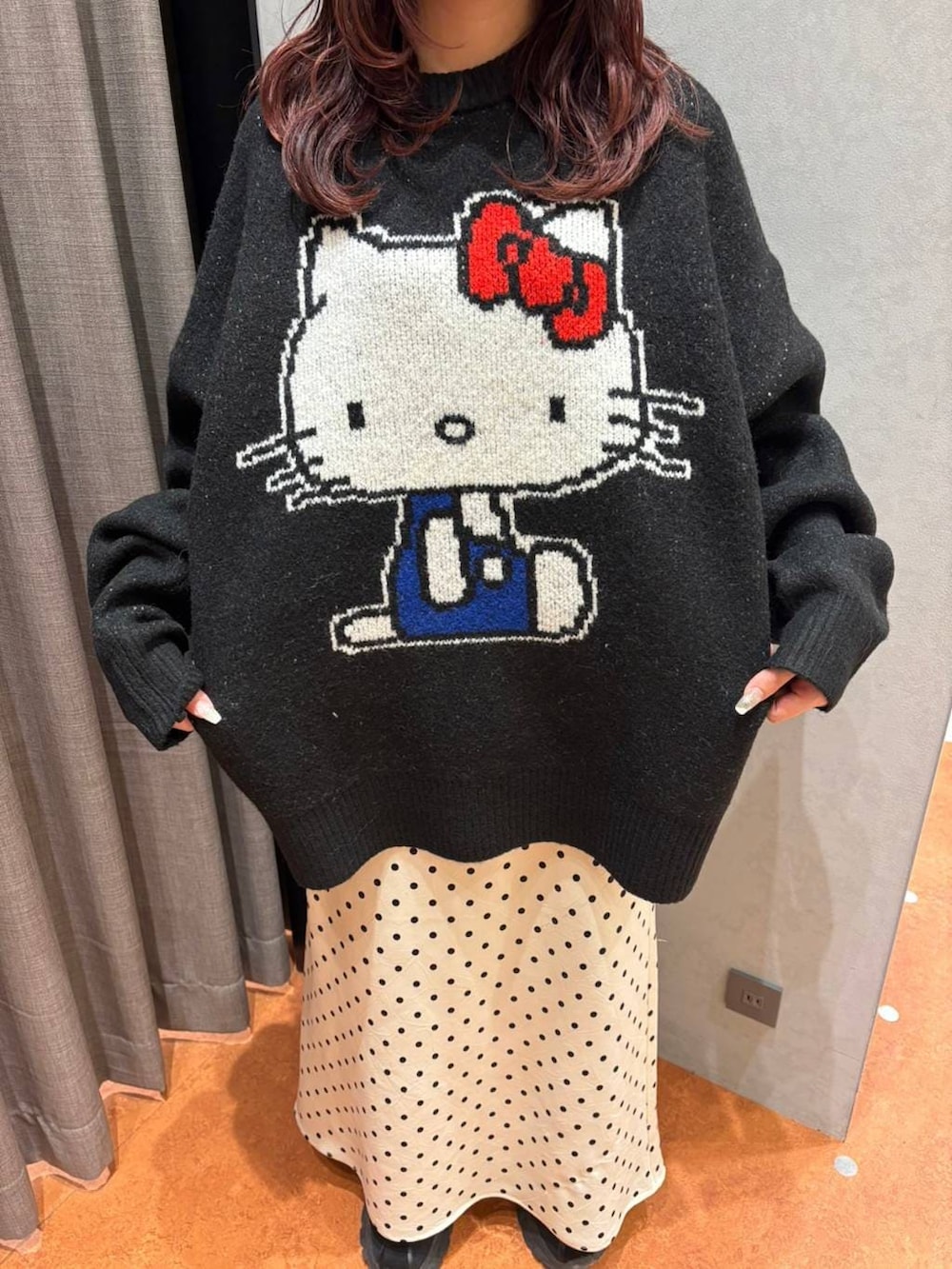 ブラック系のスカート、ホワイト系のスカート、グレー系のニット/セーターを着用したレディースの秋コーディネートの2枚目の写真