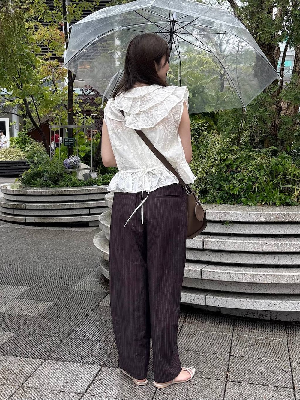 ブラウン系のその他パンツ、ホワイト系のTシャツ/カットソー、ホワイト系のネックレスを着用したレディースの夏コーディネートの3枚目の写真