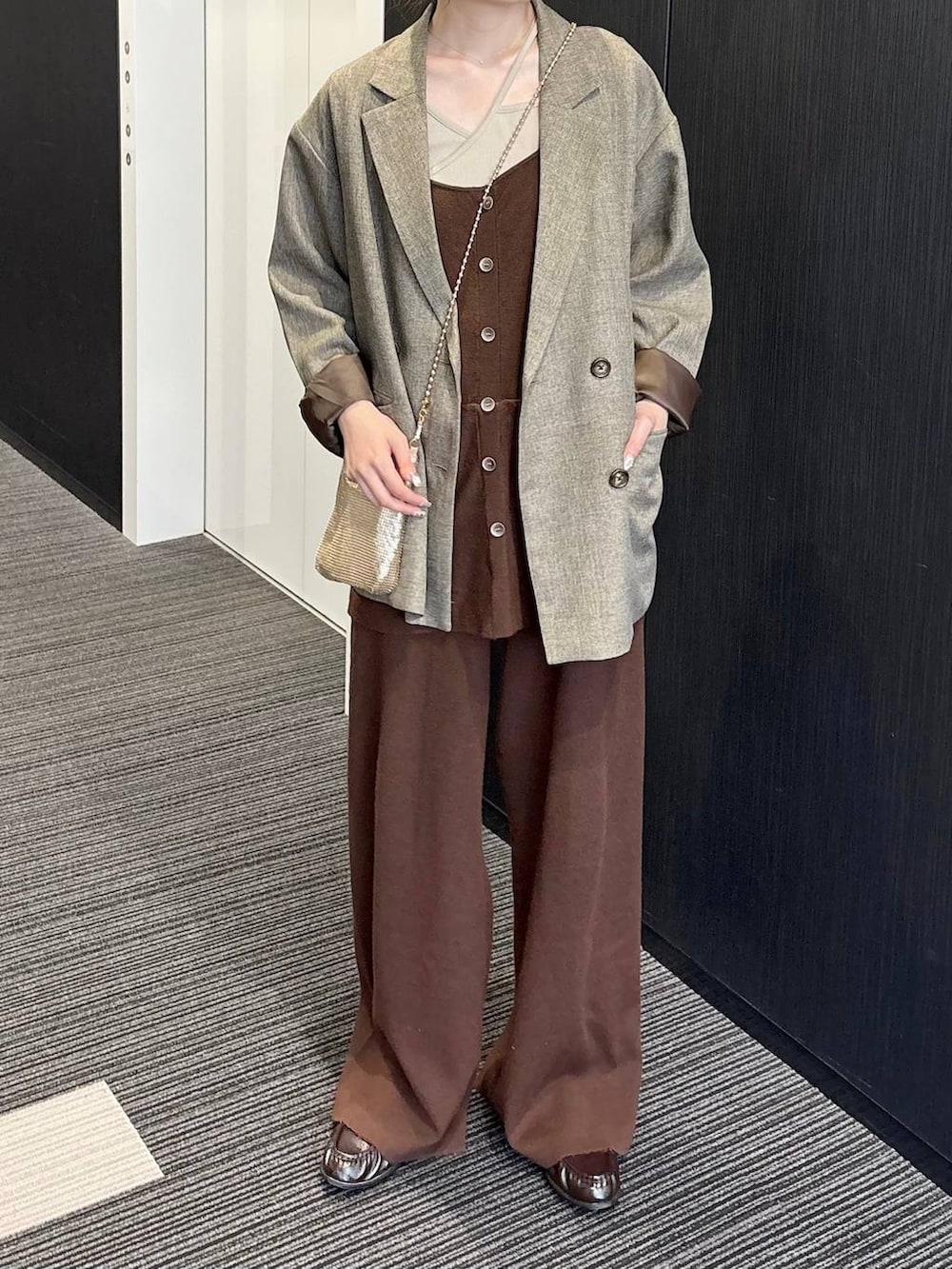 ゴールド系のショルダーバッグ、ブラウン系のテーラードジャケット、ブラウン系のつなぎ/オールインワンを着用したレディースの春コーディネートの3枚目の写真
