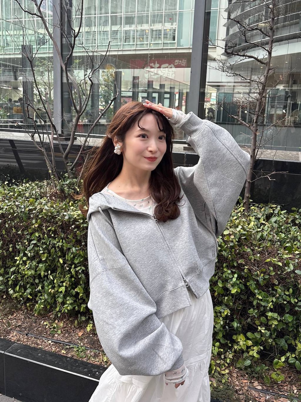 グレー系のパーカー、ホワイト系のTシャツ/カットソー、ブラウン系のローファーを着用したレディースの冬コーディネートの3枚目の写真