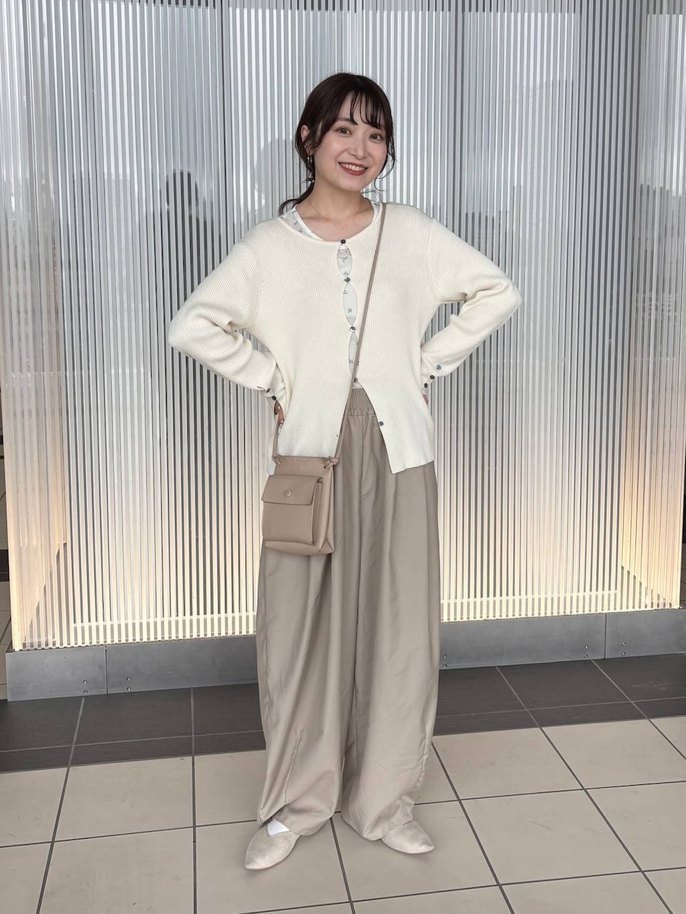 ホワイト系のニット/セーター、ベージュ系のその他パンツ、ホワイト系のTシャツ/カットソーを着用したレディースの春コーディネートの4枚目の写真