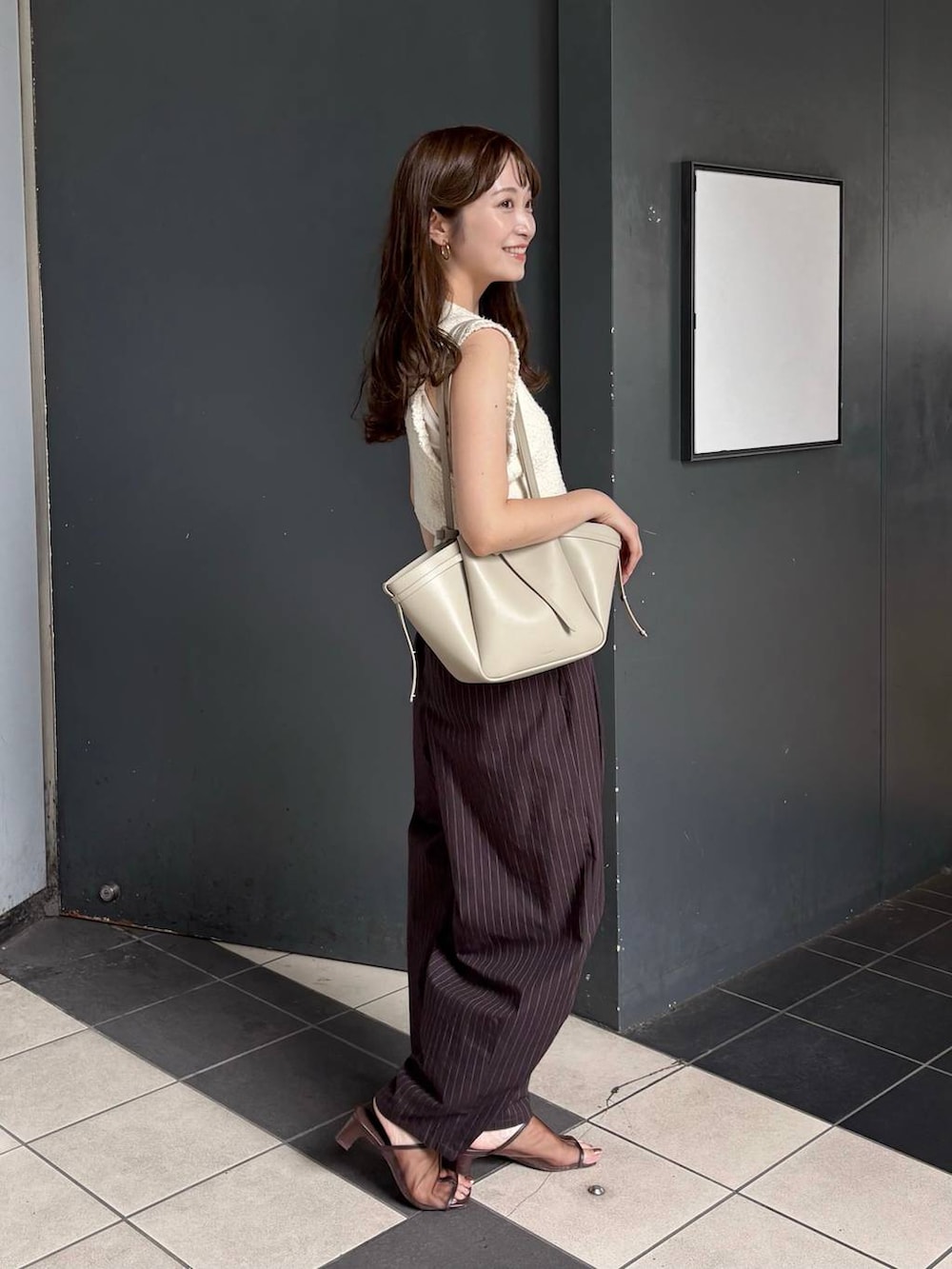 ブラウン系のその他パンツ、ブラウン系のボディバッグ/ウエストポーチ、ブラウン系のサンダルを着用したレディースの夏コーディネートの2枚目の写真