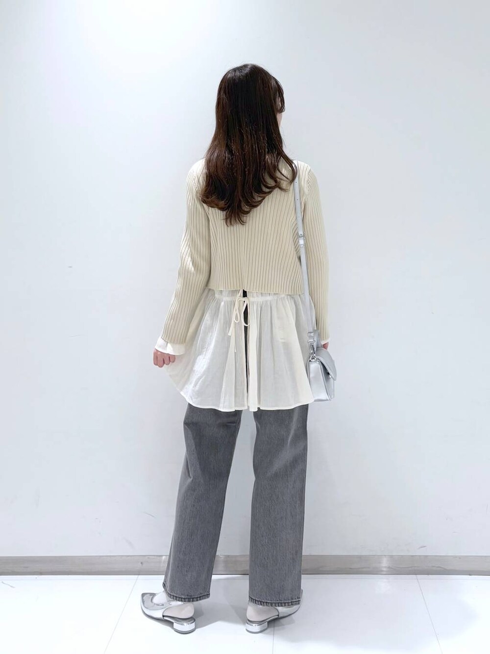 ホワイト系のシャツ/ブラウス、ホワイト系のカーディガン/ボレロ、グレー系のデニムパンツを着用したレディースの春コーディネートの3枚目の写真